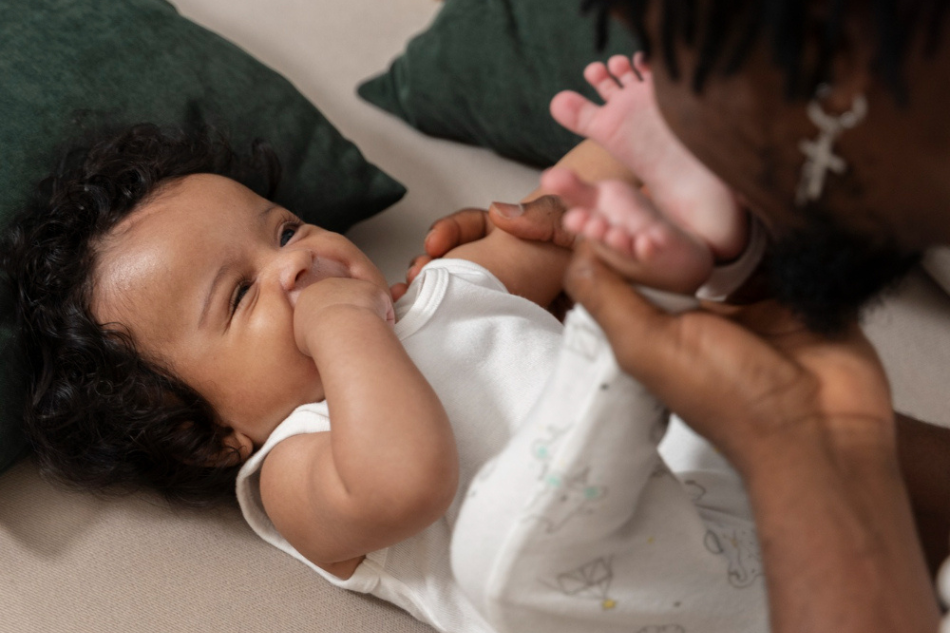 Bébé métisse jouant avec son papa